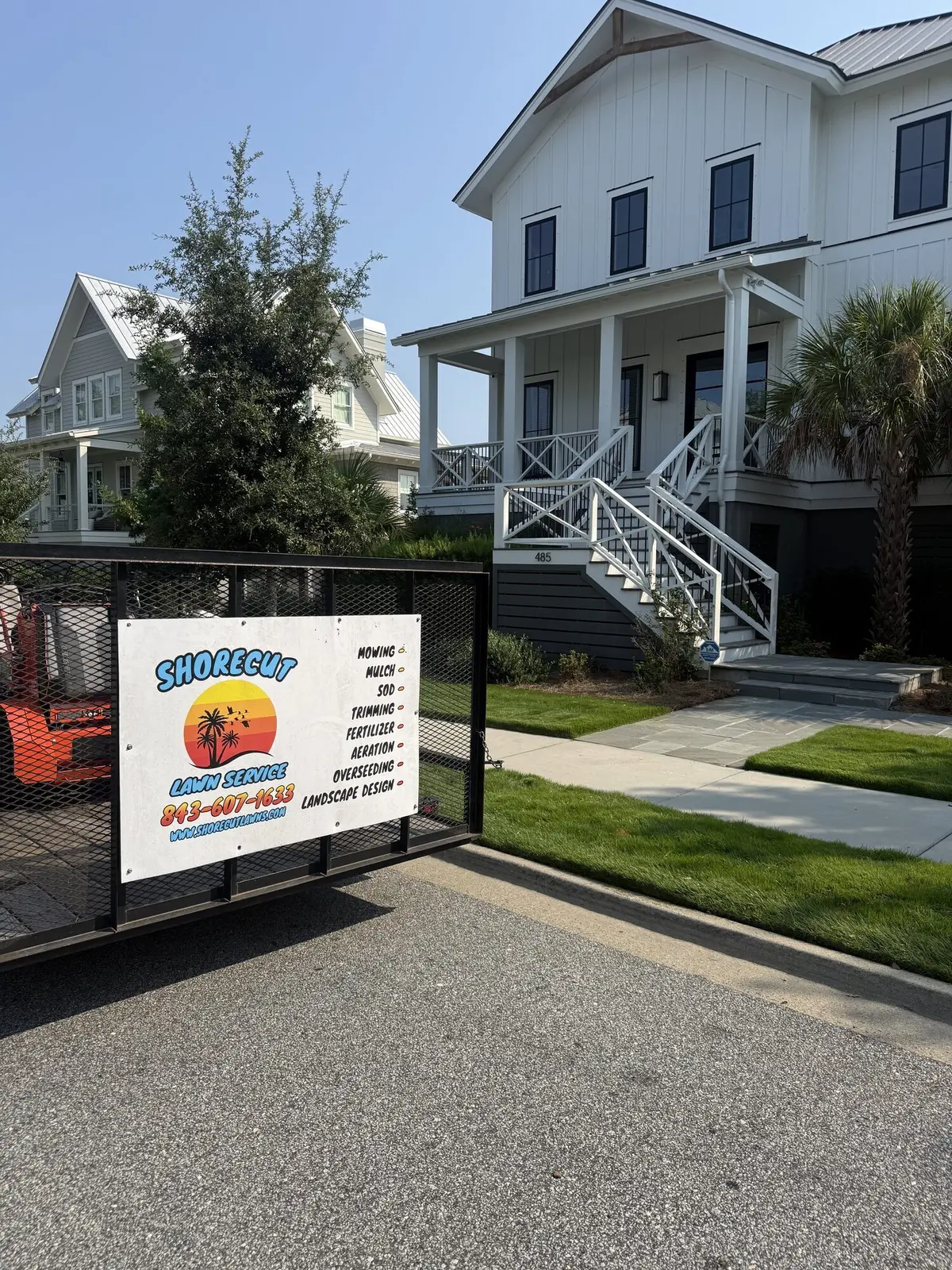 A ShoreCut Lawn Service job sign in front of a Lowcountry home