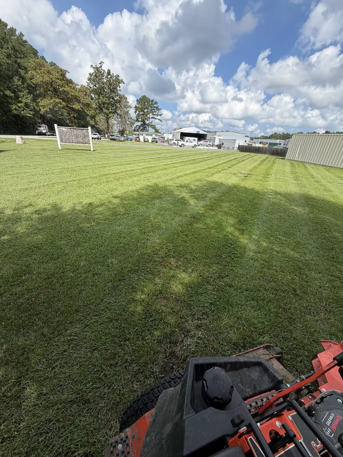 A striped lawn beside a commercial warehouse property near Goose Creek