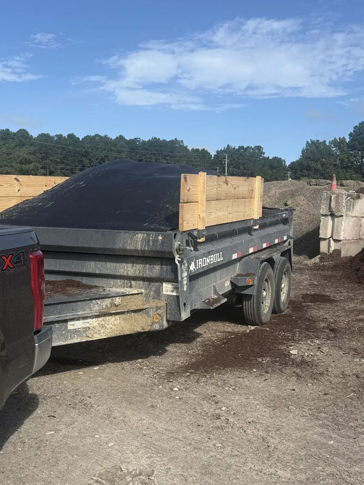 A supply trailer loaded with mulch and landscaping materials