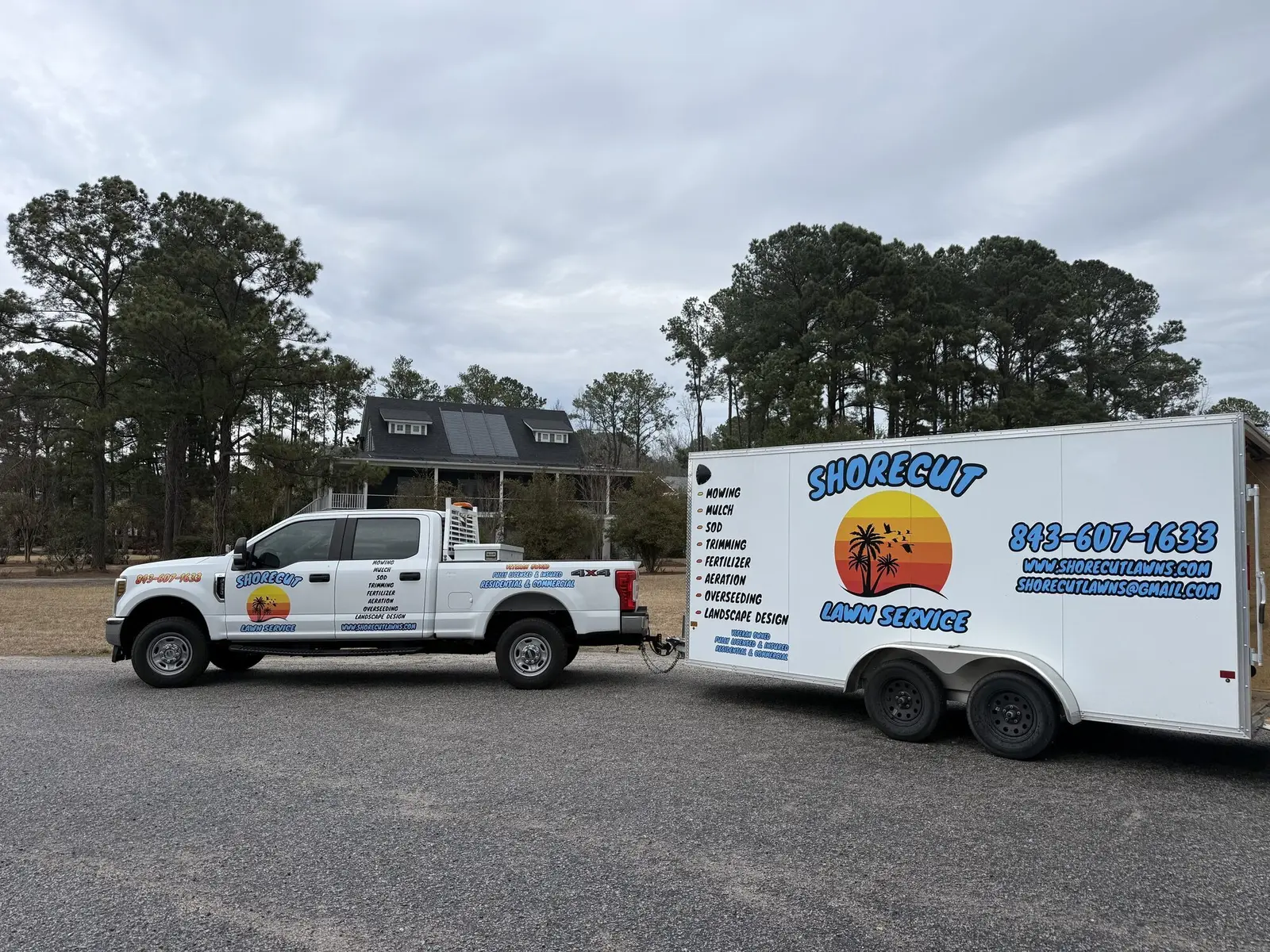 The ShoreCut branded truck and trailer parked in front of a job
