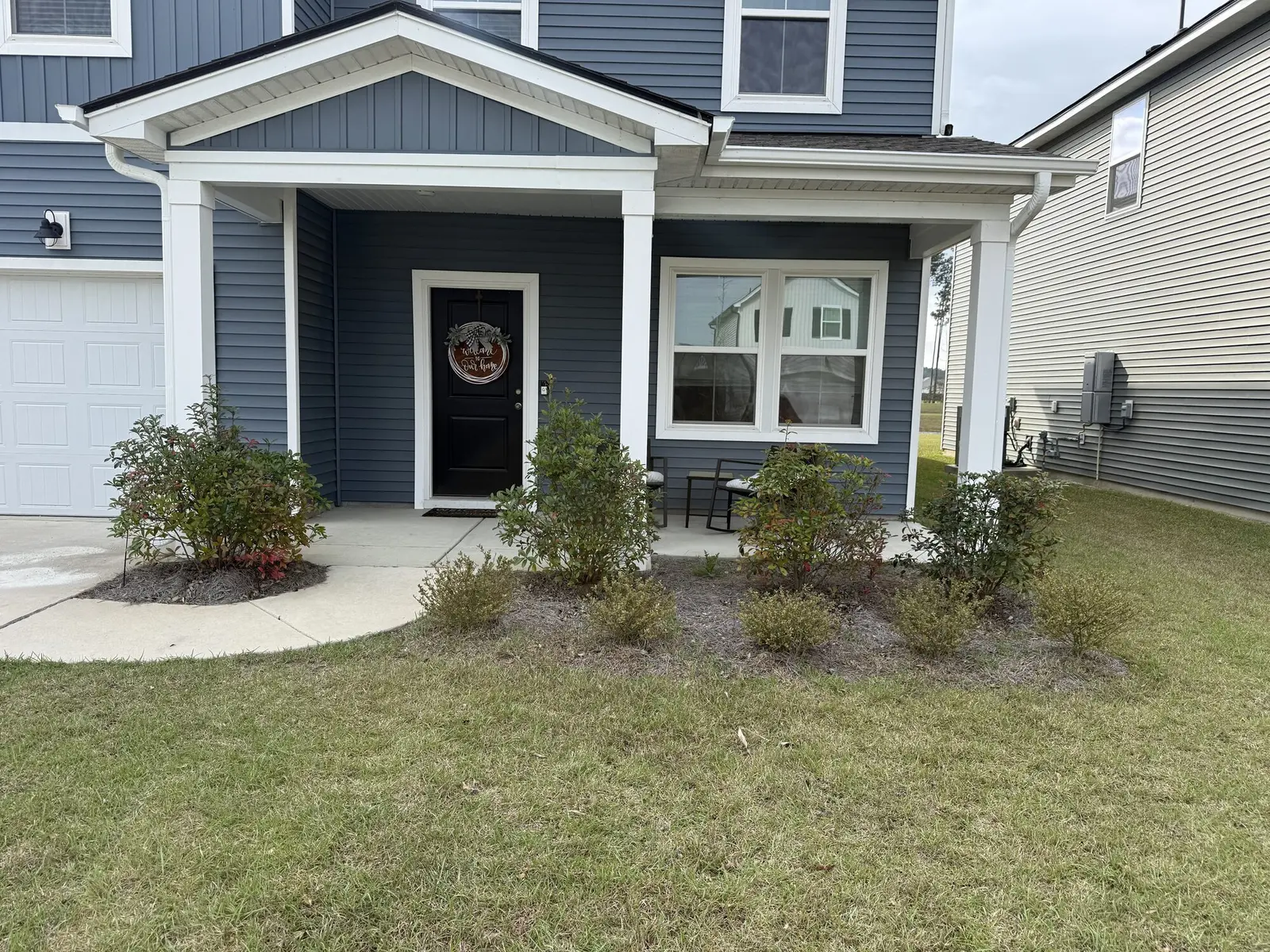 A front porch planting bed with fresh mulch